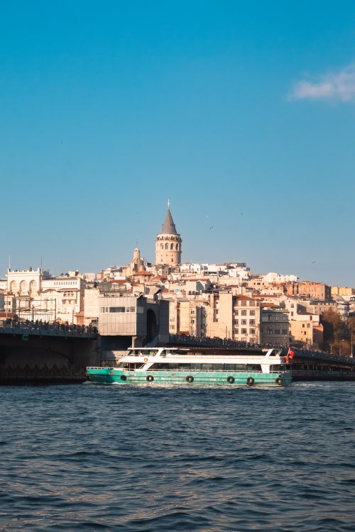 Free Scenic view of Galata Tower and boat on the Bosphorus in Istanbul, Turkey. Stock Photo