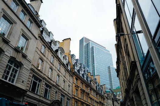 Street view of modern skyscraper juxtaposed with classic architecture.