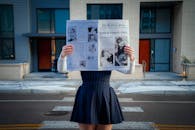 Fashionable Portrait with Newspaper in Urban Setting