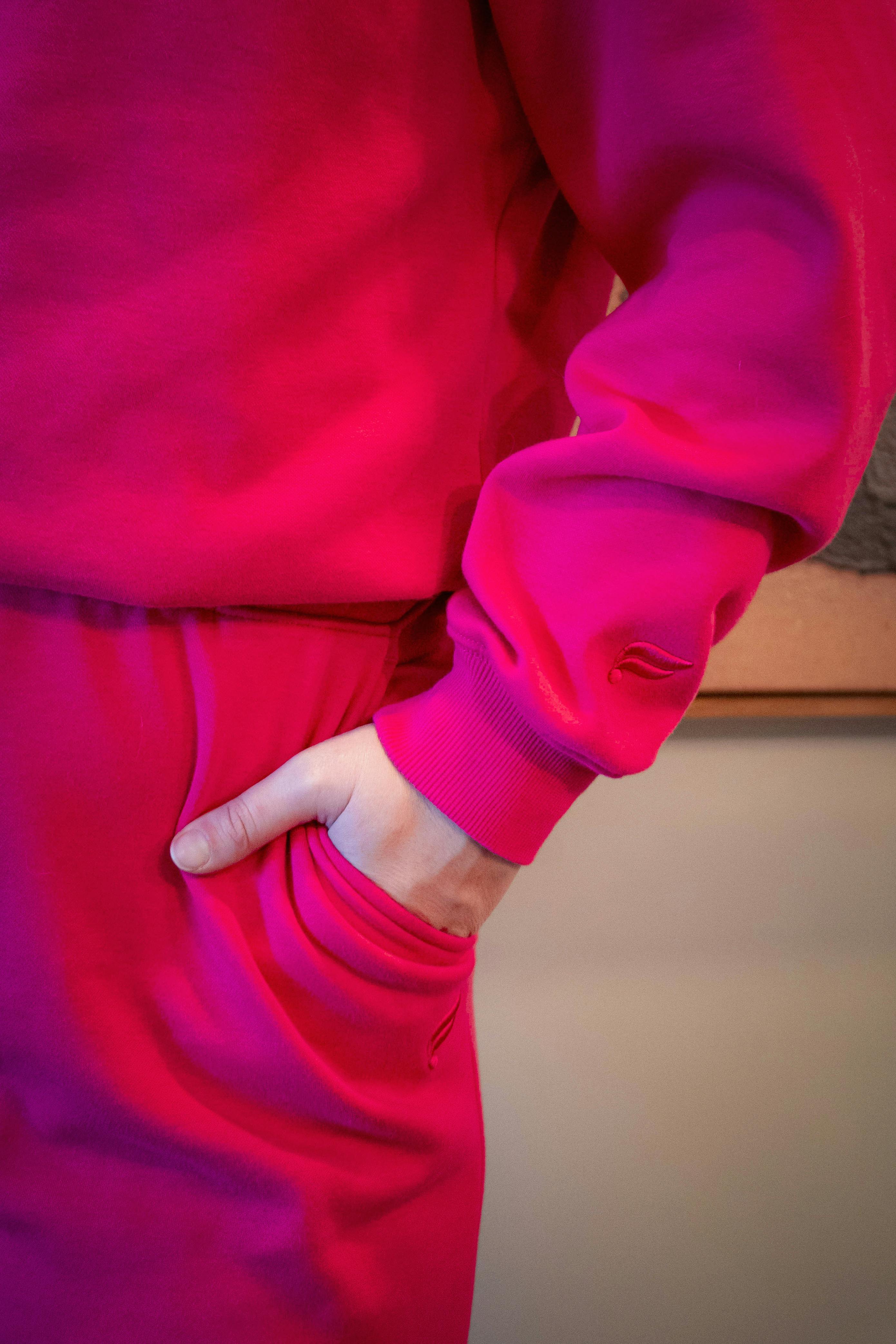 Free Close-up of a vibrant pink outfit in a cozy, indoor setting. Perfect for fashion and lifestyle imagery. Stock Photo
