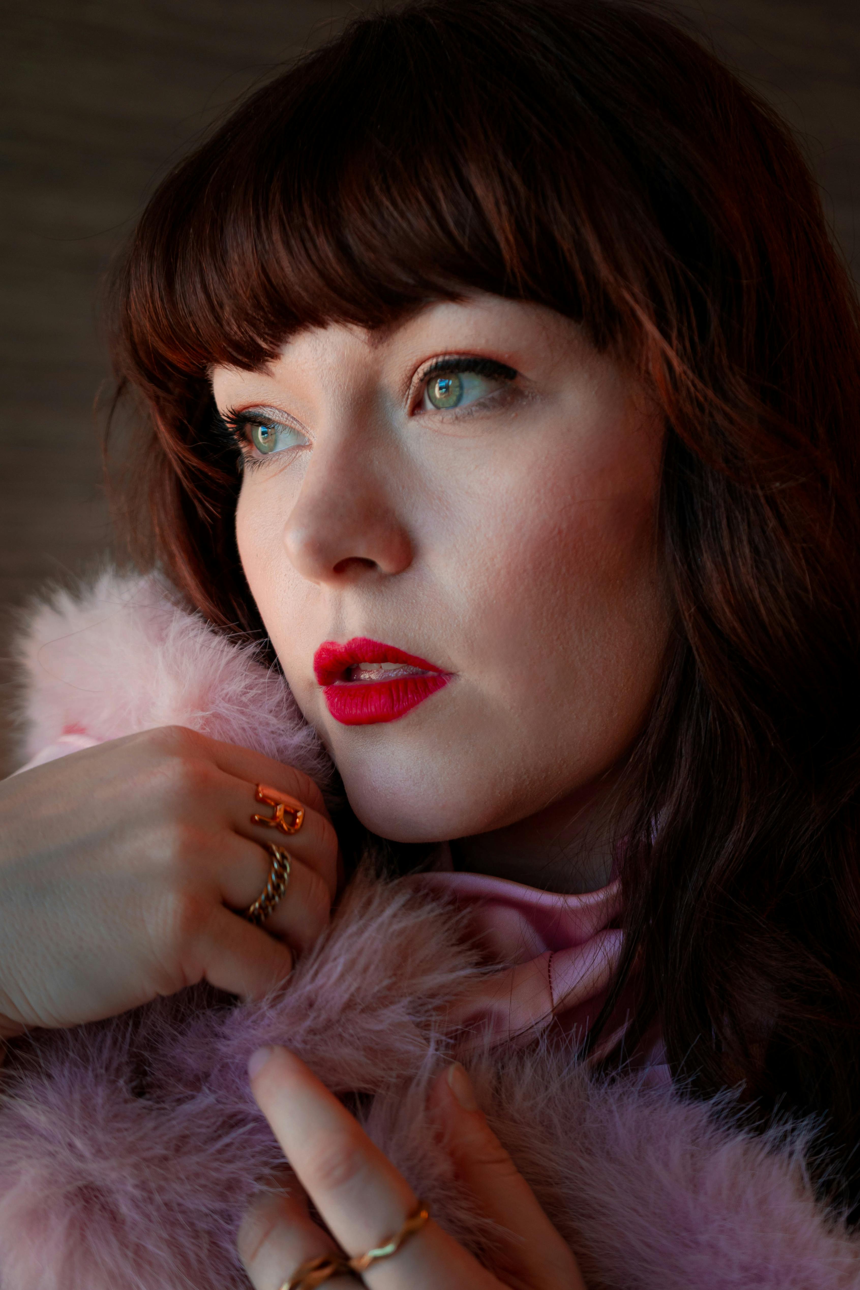 Stylish portrait of a woman in soft pink attire, showcasing artistic fashion photography.