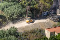 Bulldozer on Dusty Path in Lush Lisbon Environment
