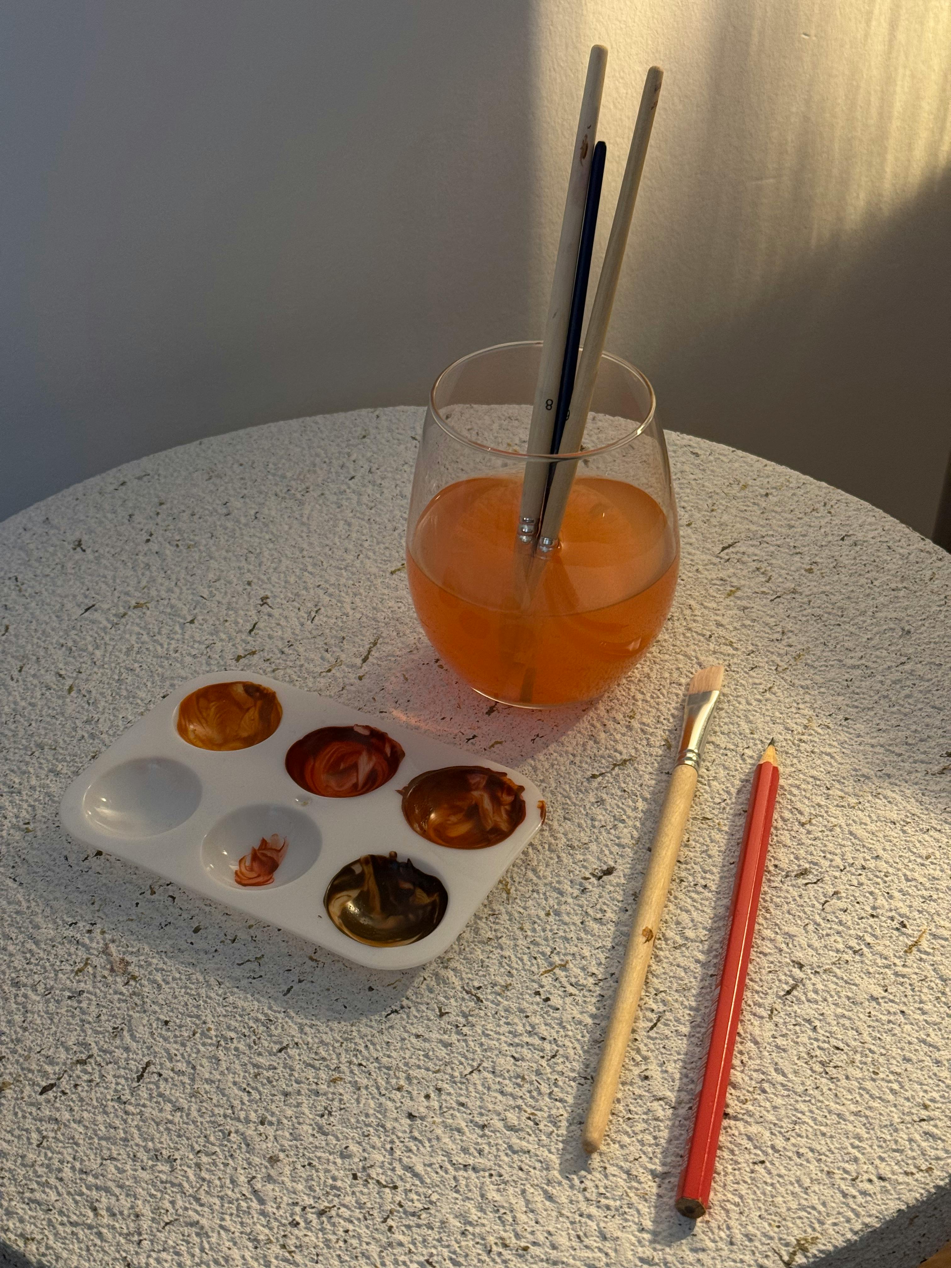 Gratis Perlengkapan seni berwarna-warni termasuk palet cat, kuas, dan pensil di atas meja bertekstur. Foto Stok