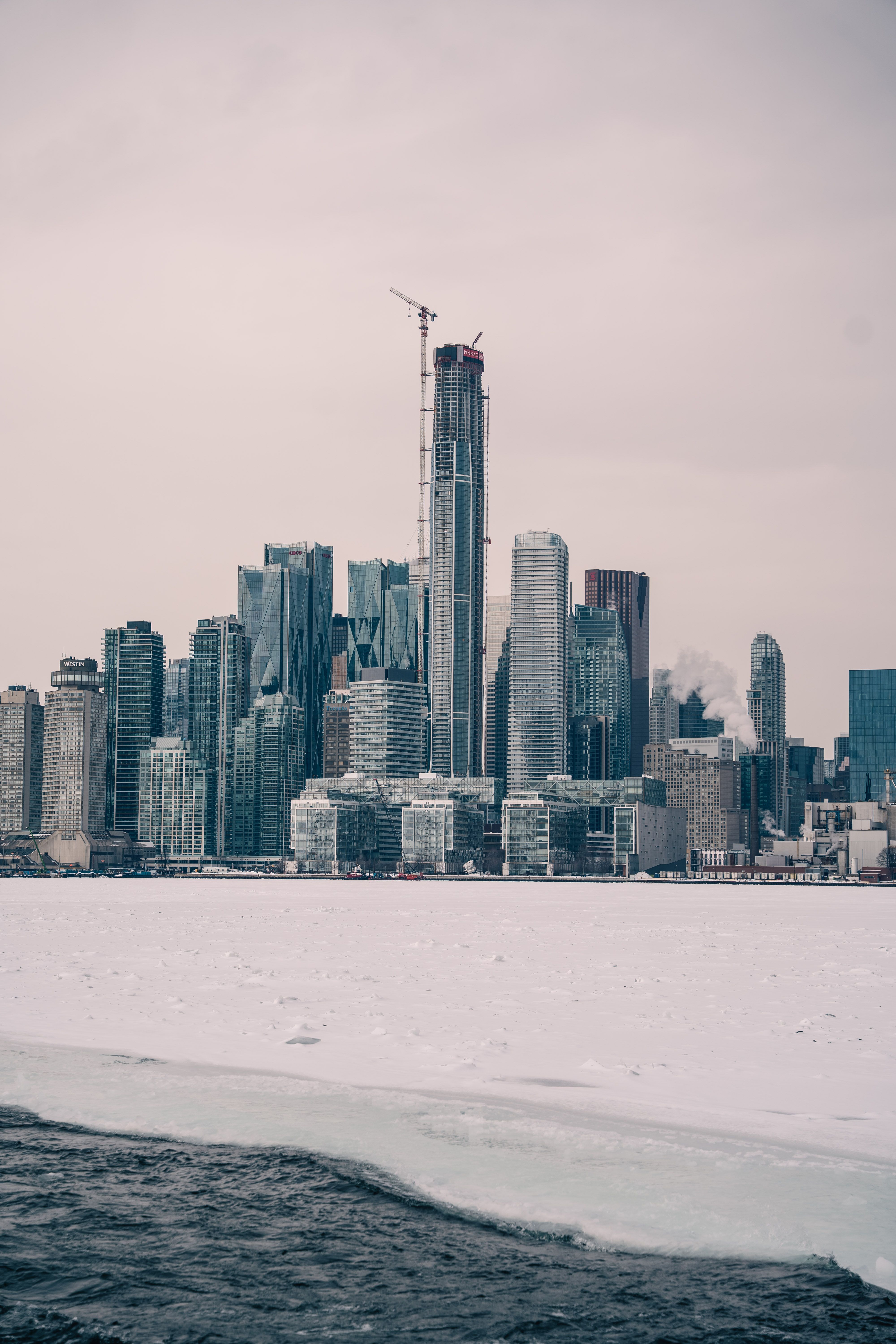 A scenic view of New York City's skyline covered in snow, captured during the winter season.