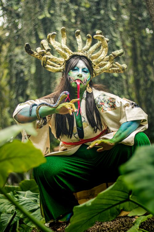 Free Artistic cosplay featuring fantasy and snakes in a lush outdoor setting in Mexico City. Stock Photo