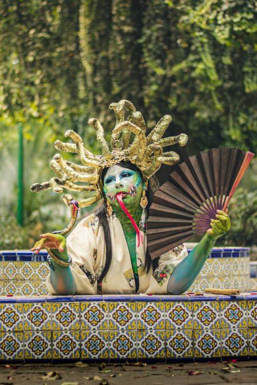 Free Colorful cosplay featuring intricate fantasy makeup and costume in an outdoor setting. Stock Photo