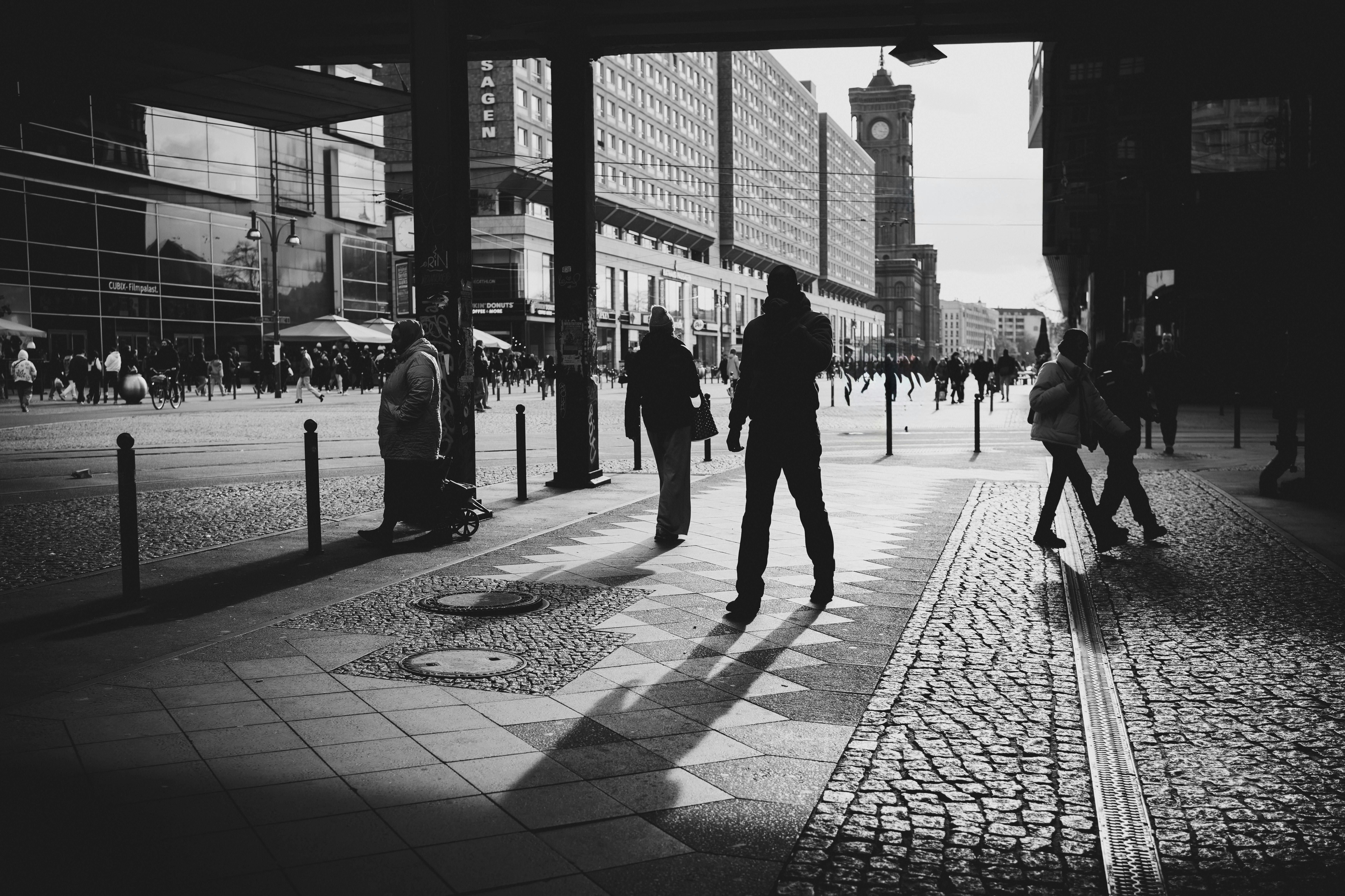 Free Dynamic urban street scene in black and white with silhouetted pedestrians and iconic architecture. Stock Photo