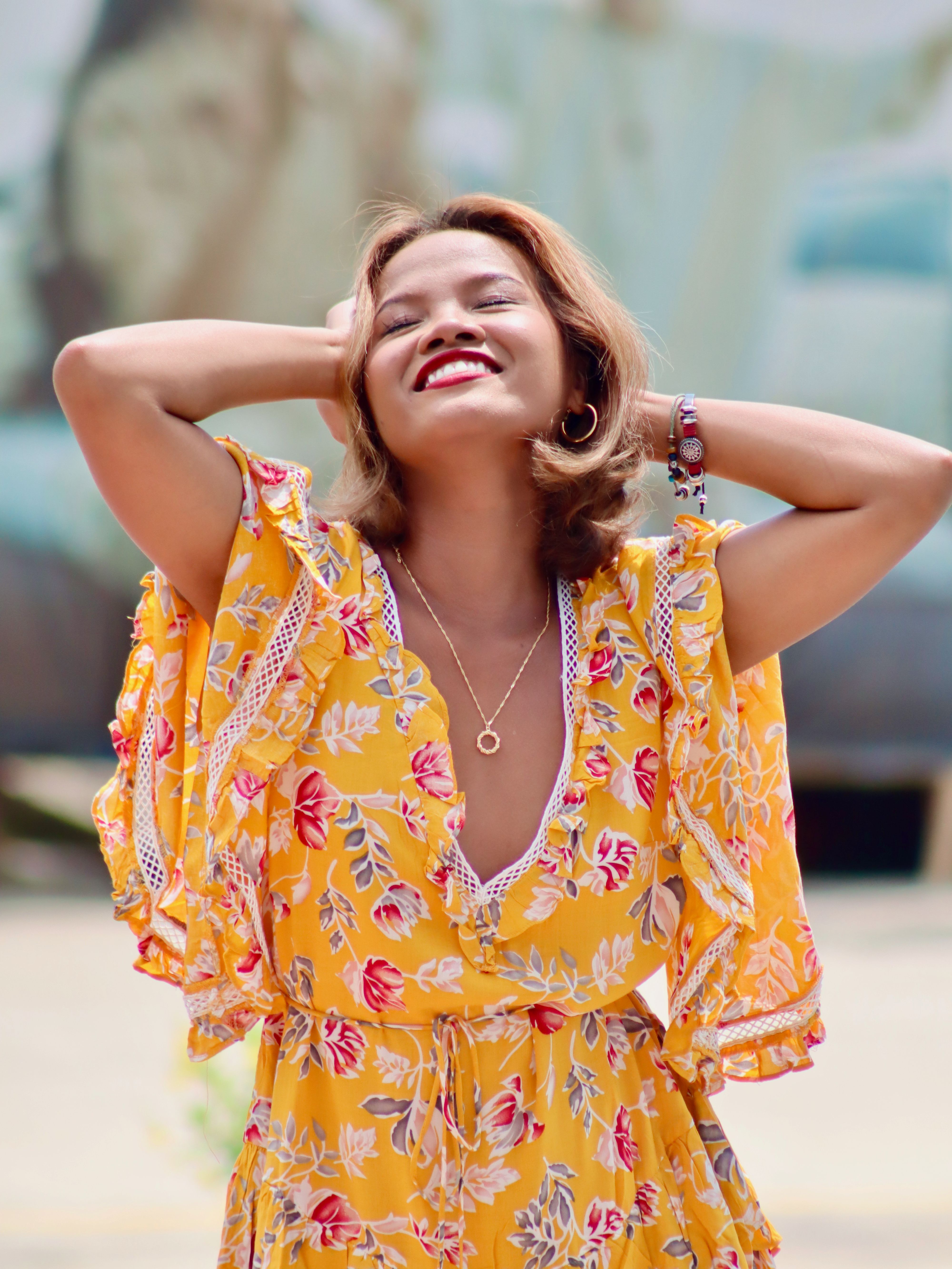 Joyful Woman in Floral Dress Outdoors · Free Stock Photo