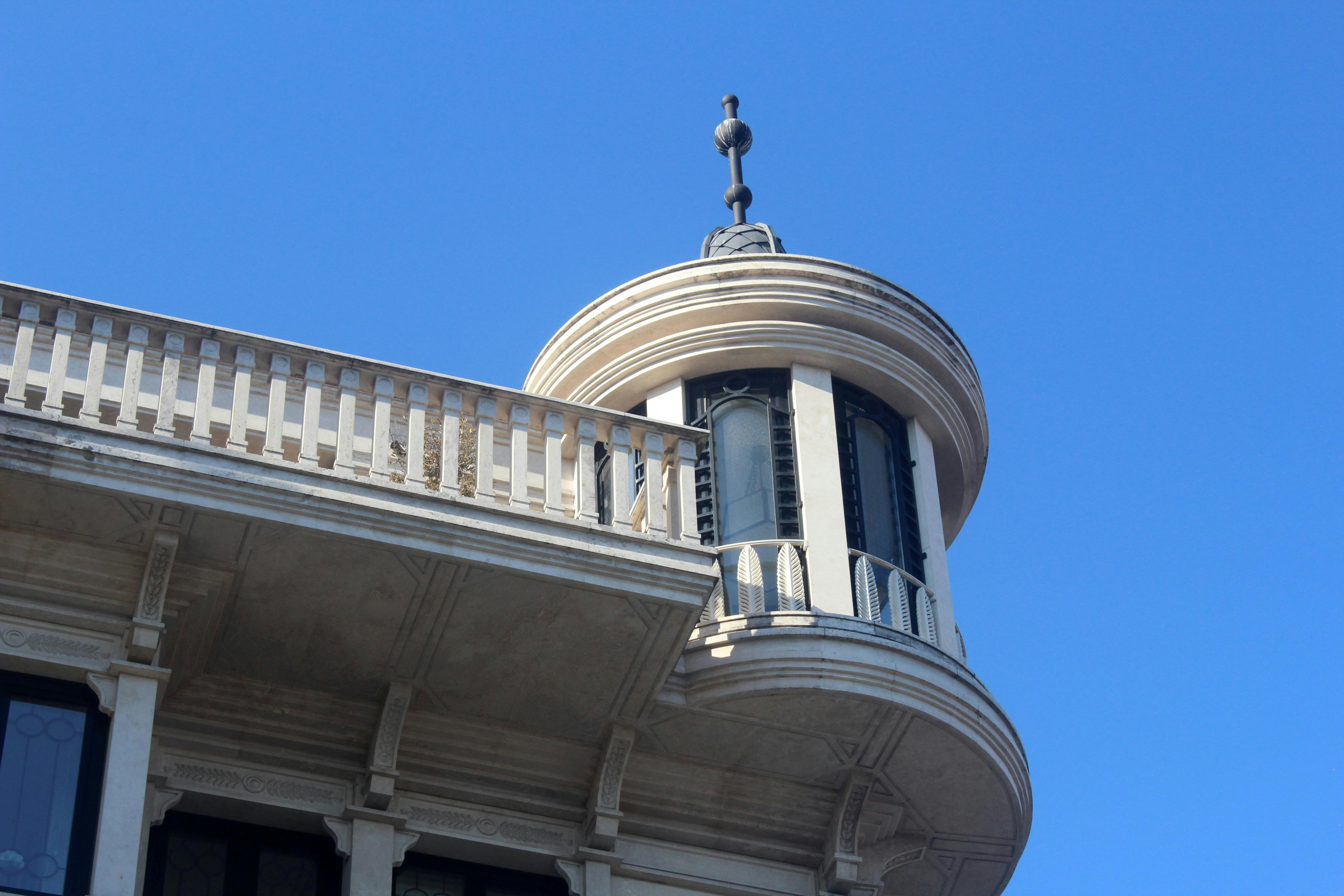 Free Close-up of a historical building's circular corner tower under a clear blue sky. Stock Photo