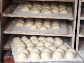 Fresh Bread Dough Rising on Baking Racks