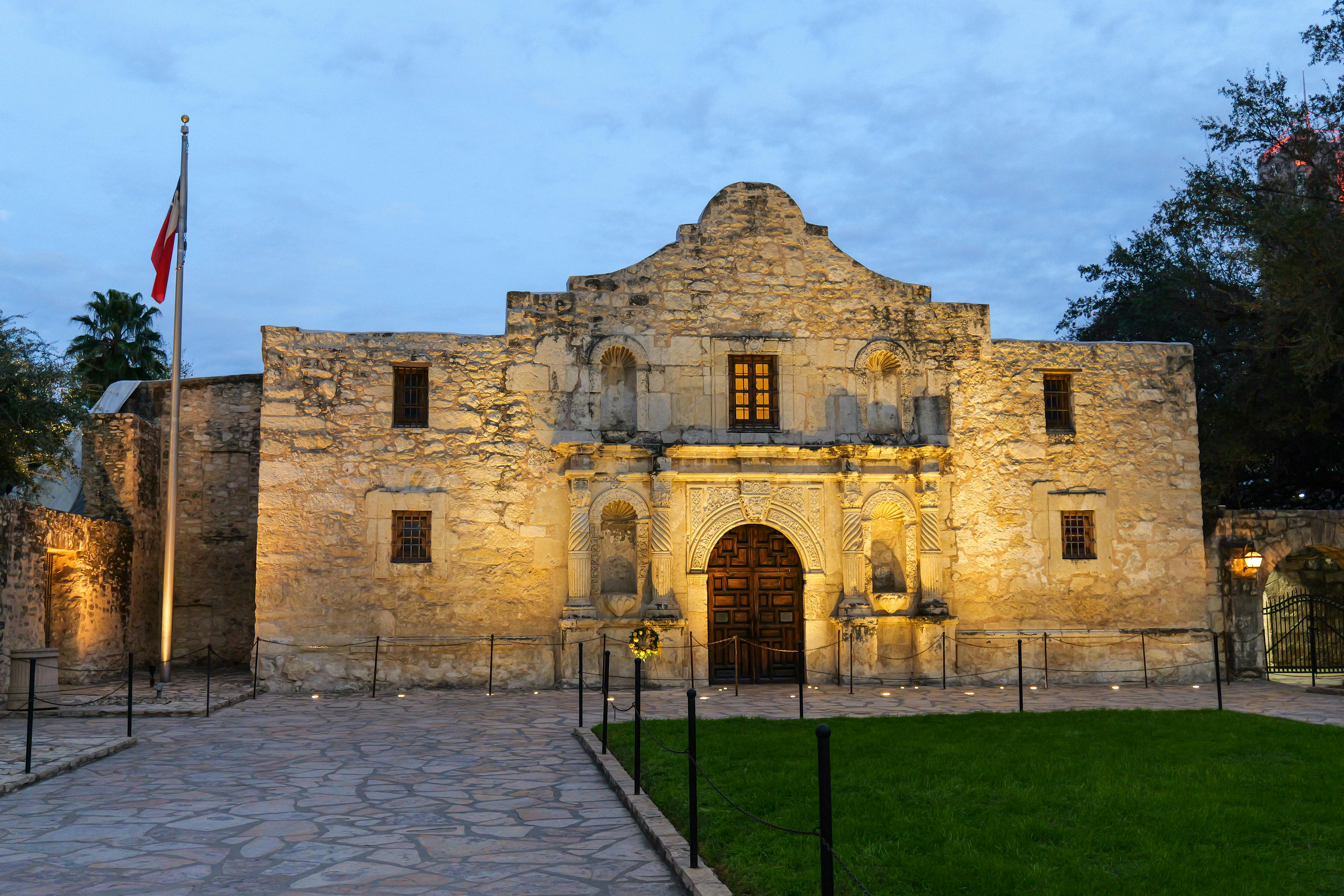The historic Alamo in San Antonio, Texas, beautifully lit at dusk, showcasing its iconic architecture.