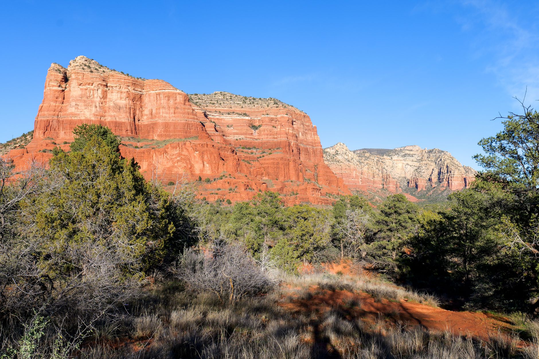 Explore the breathtaking red rock formations and landscapes in Sedona, Arizona, under a clear blue sky.