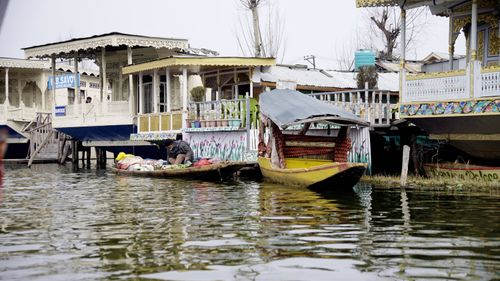 Free Shikara boats floating by decorated houseboats on Dal Lake, Kashmir, India. Stock Photo