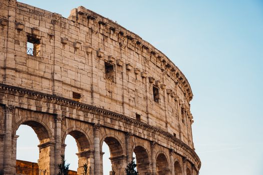 A vibrant daylight image of the iconic Roman Colosseum showcasing ancient architecture.