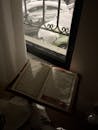 Open Book by Window with Snow Outside