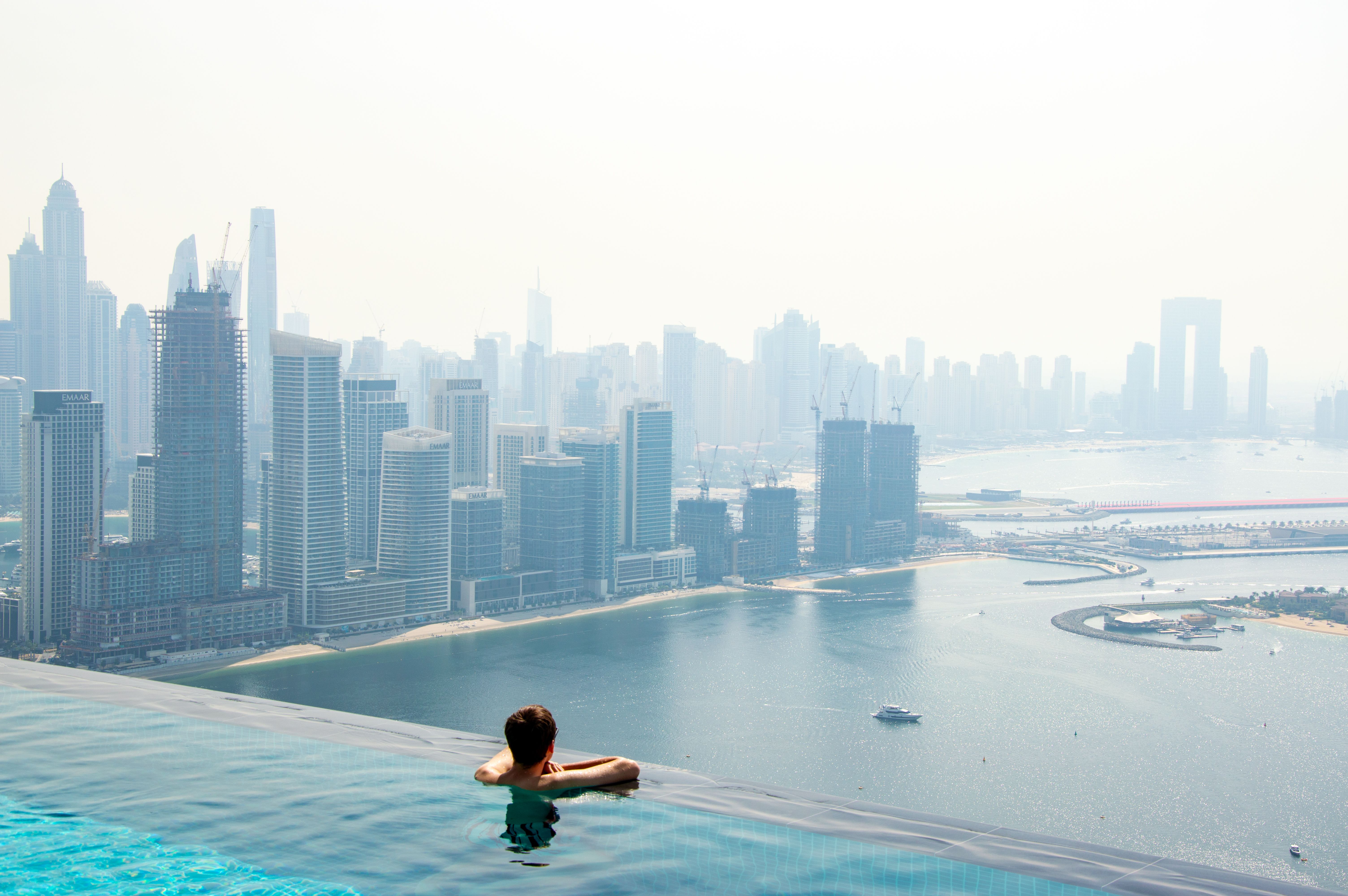 A serene moment in an infinity pool with a stunning view of Dubai's skyline.