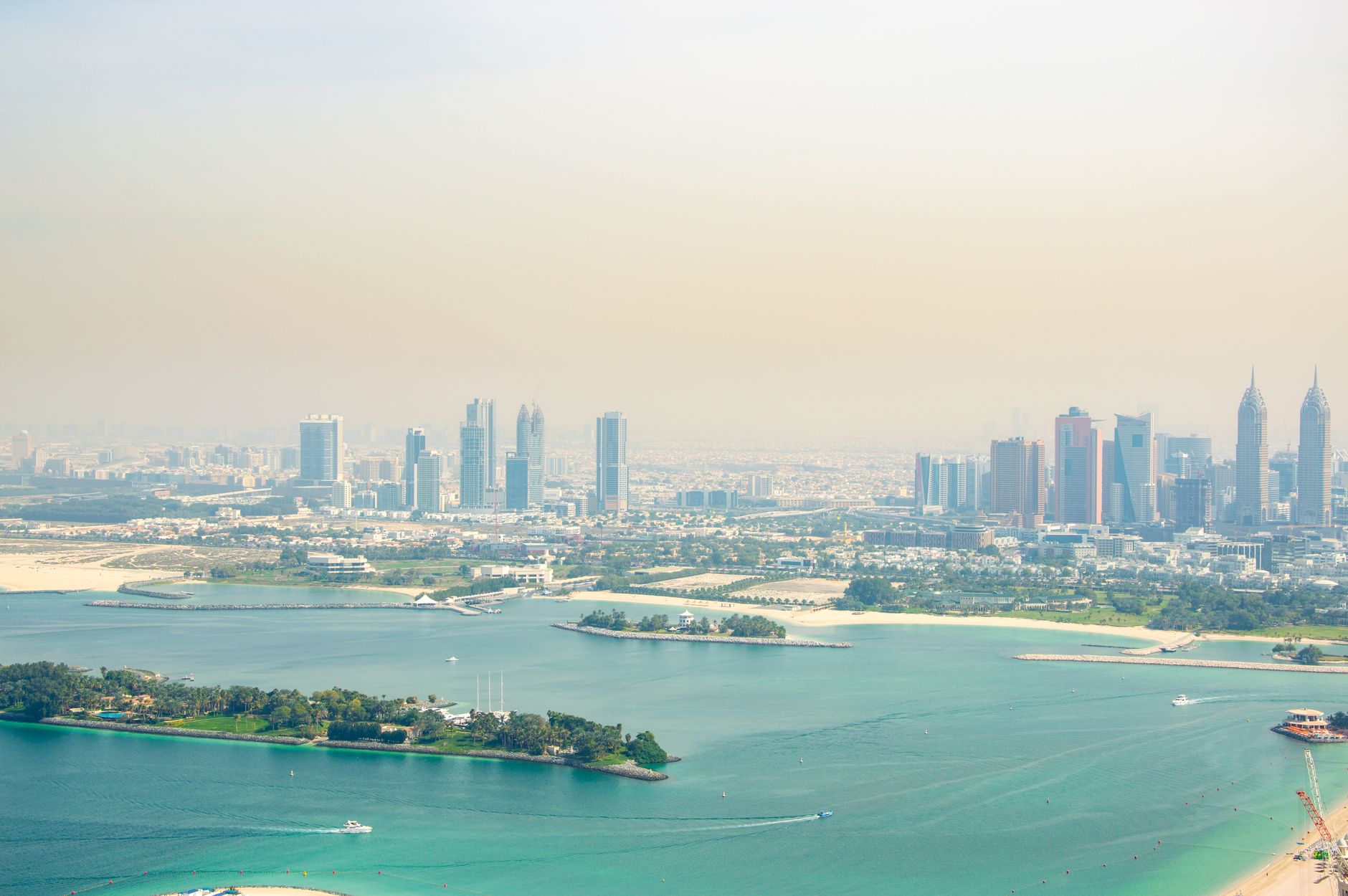 Stunning aerial view of Dubai's skyline with pristine coastline and turquoise waters.