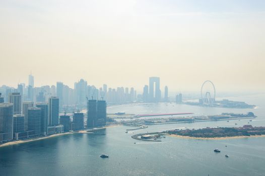 A stunning aerial view of Dubai Marina's skyline, featuring modern skyscrapers and the iconic ferris wheel in the distance.