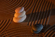 Serene Zen Stones on Patterned Sand Background