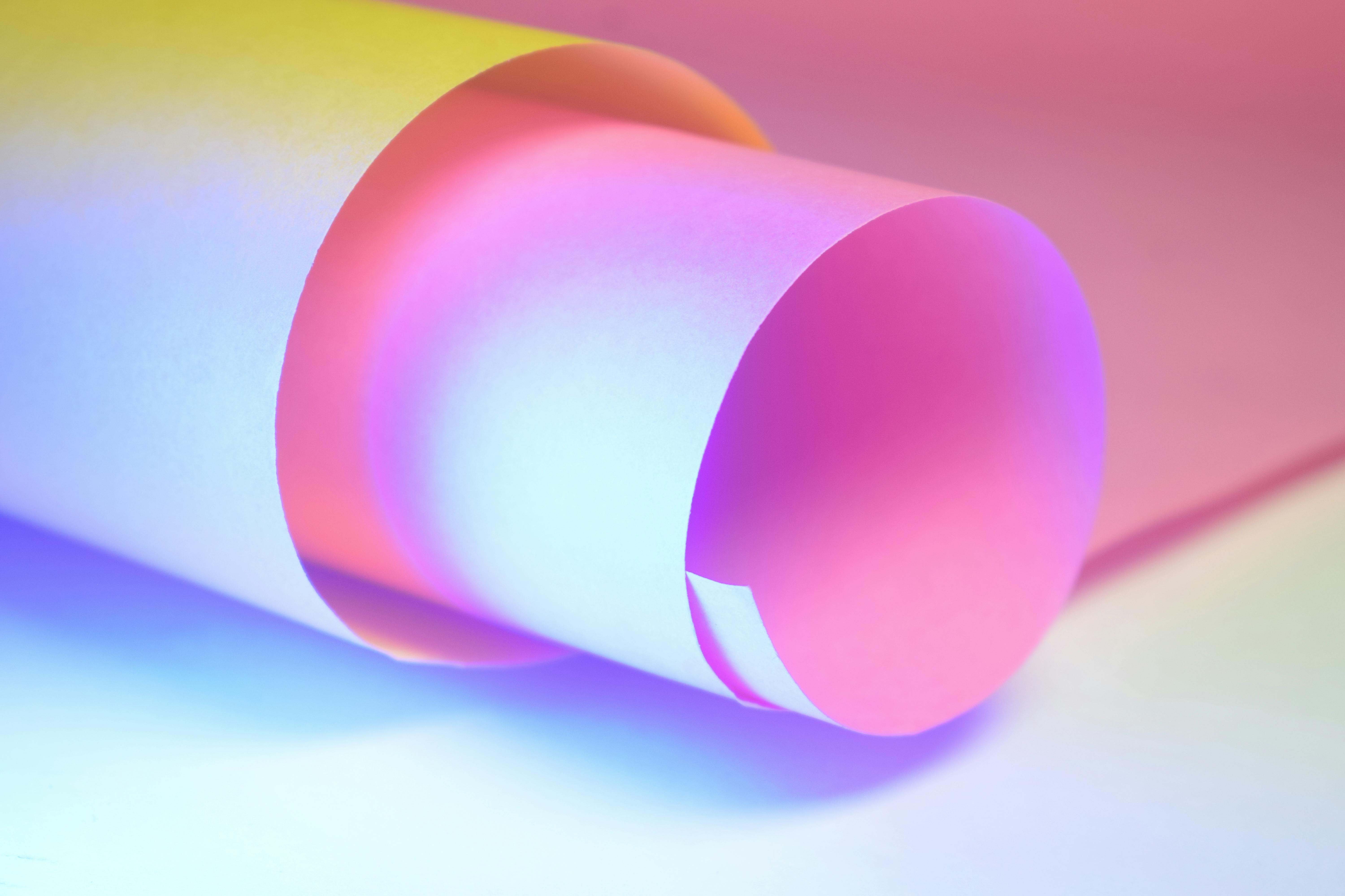 Free Abstract photograph featuring rolled paper with vivid gradient lighting effects and textures. Stock Photo