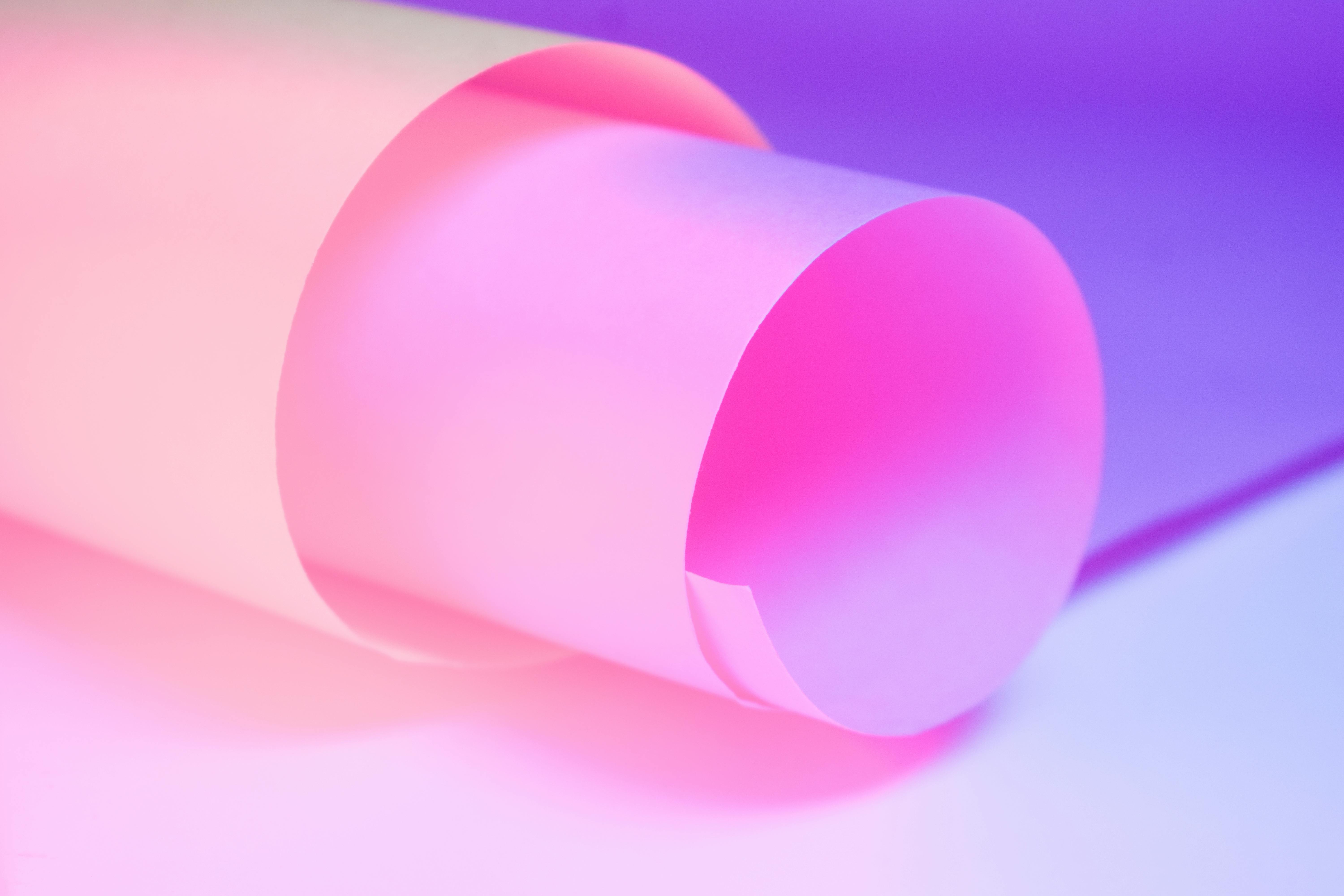 Free A vivid abstract art of rolled paper with gradient pink and purple hues. Stock Photo
