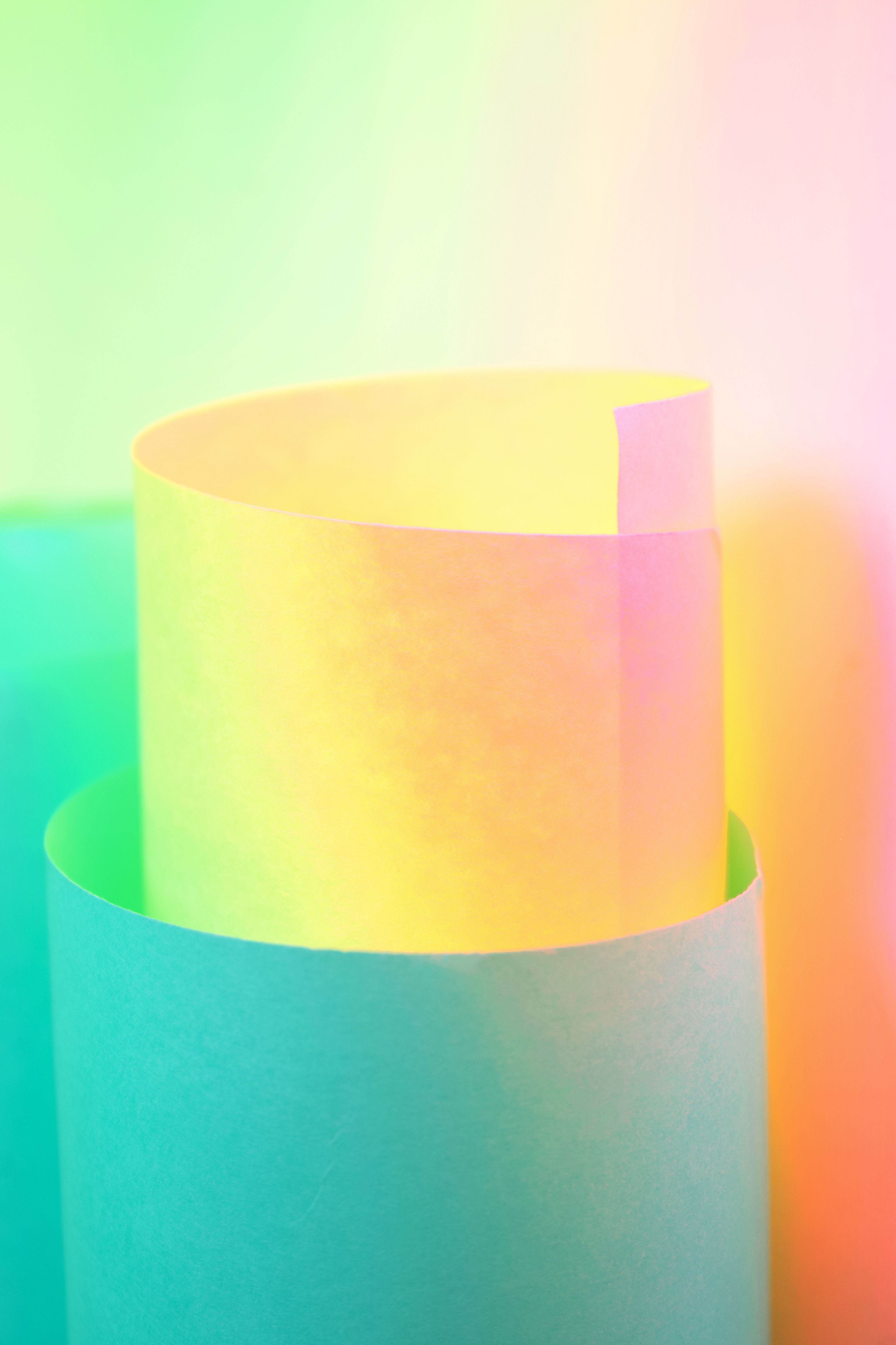 A vibrant and colorful abstract photo of rolled paper with a soft gradient effect.