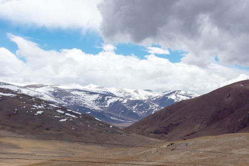 Free Breathtaking view of snow-capped mountains under a cloudy sky in Ngari, Tibet, showcasing natural beauty. Stock Photo