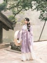 Elegant Woman in Traditional Asian Dress by Pond