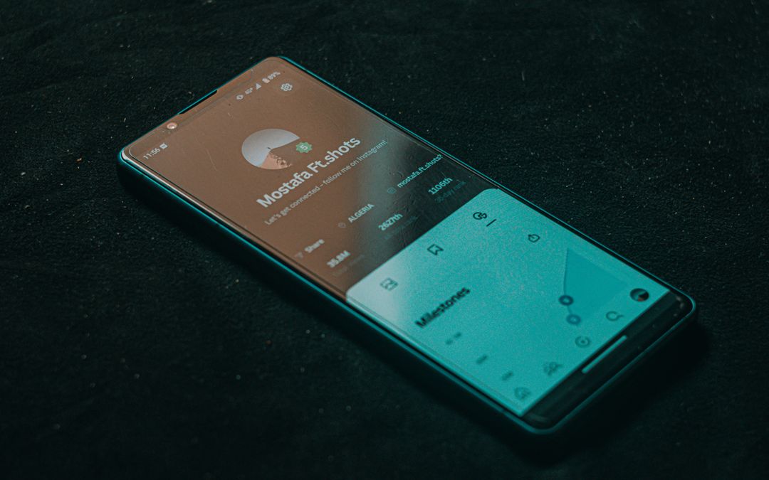 Smartphone showing an app interface on a dark surface