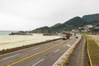 Scenic Coastal Road with Trucks and Ocean View