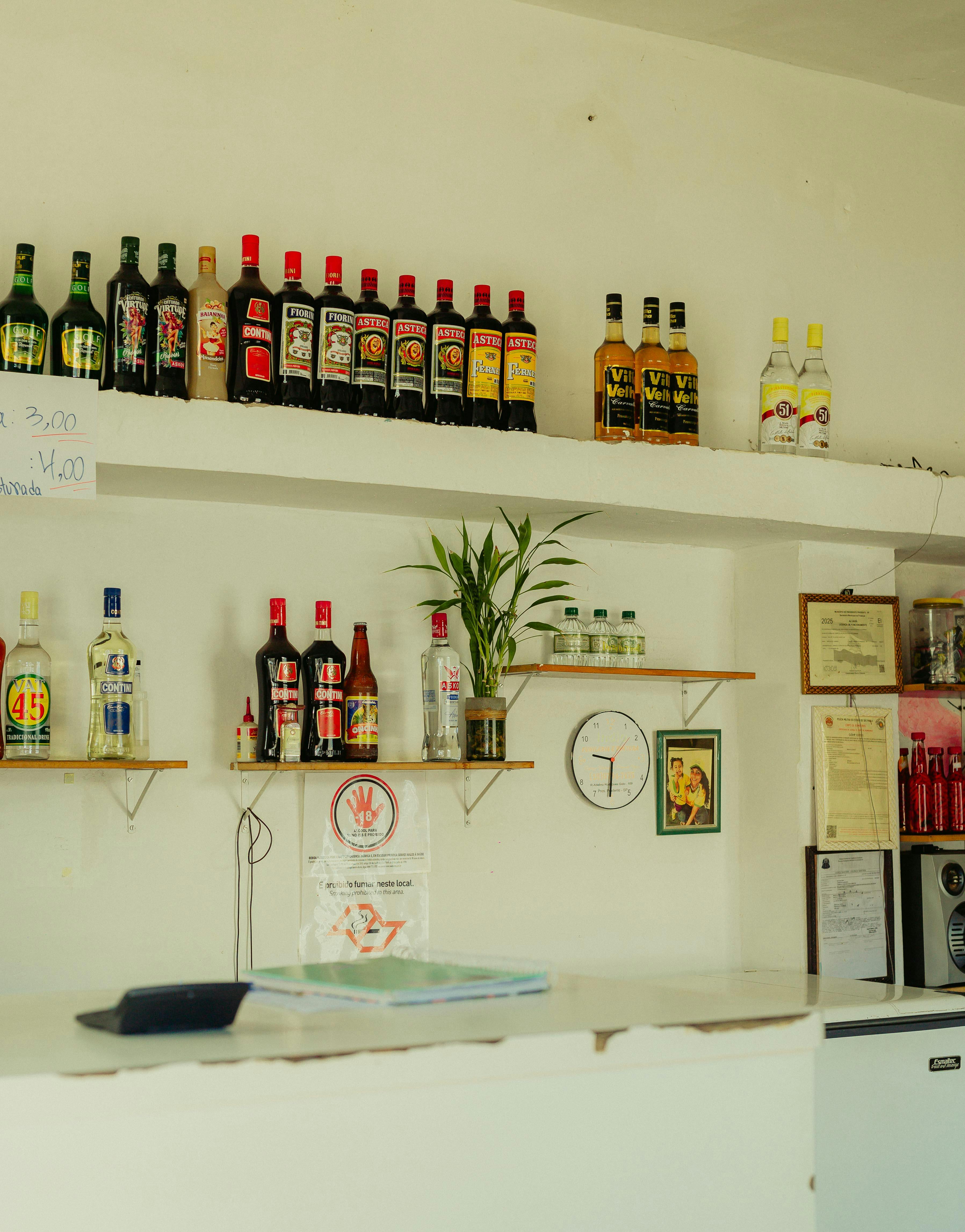 A vibrant indoor bar scene featuring an assortment of liquor bottles on shelves, perfect for nightlife and beverage themes.