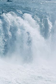 Powerful waterfall crashing down rocks, capturing the beauty of nature.
