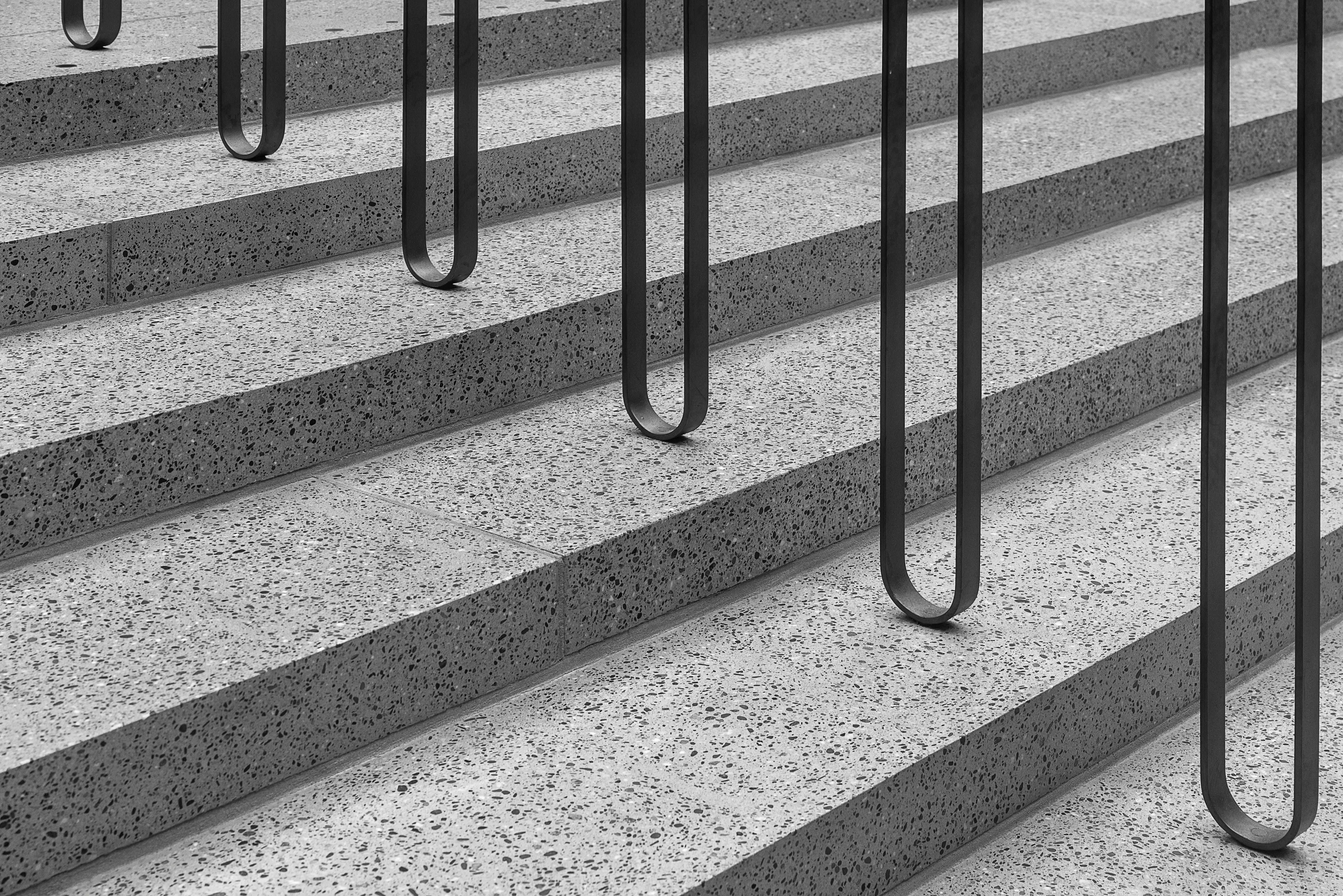 Free Elegant black and white shot of a modern staircase with minimalistic railings. Stock Photo