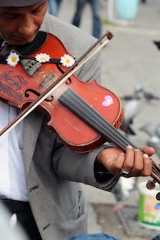 A street musician in Istanbul, Turkey, skillfully plays a decorated violin outdoors.
