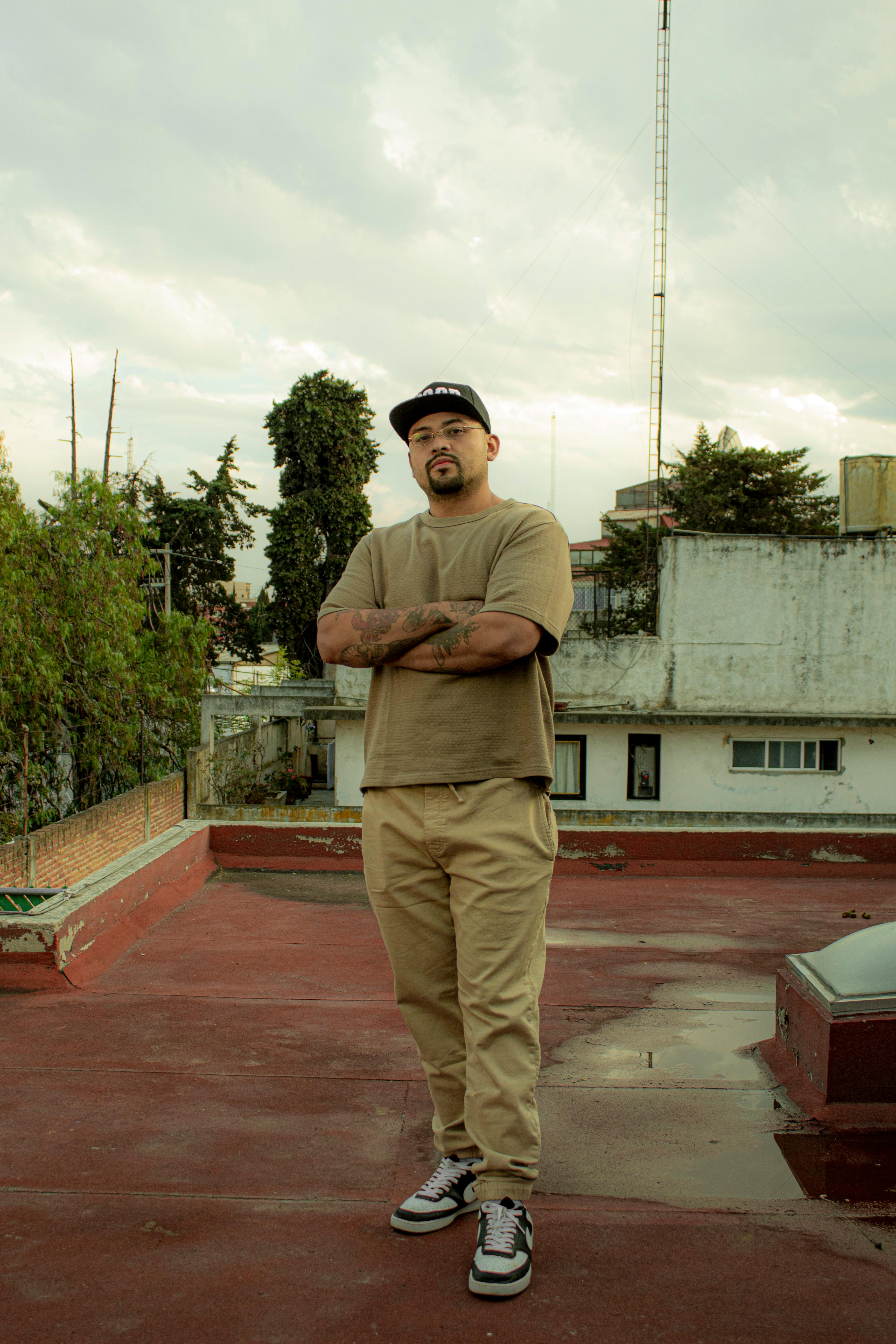 Man standing confidently on a rooftop in Mexico City, urban vibe.