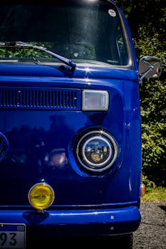 Close-up of a classic blue Volkswagen van front outdoors on a sunny day in Santa Catarina, Brazil.