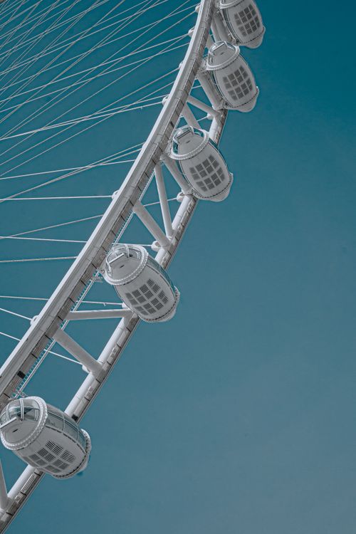 Free Close-up of Dubai's iconic Ferris wheel set against a clear blue sky, highlighting modern architecture. Stock Photo