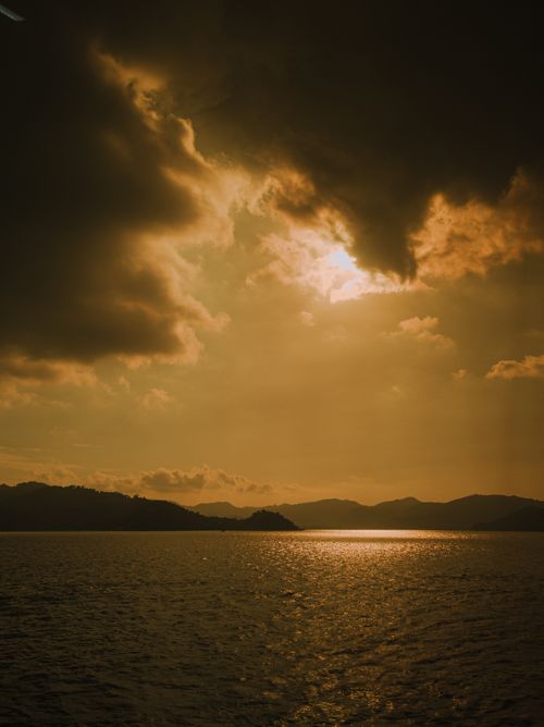 Free Dramatic sunset with golden hues over the Langkawi coastline in Kedah, Malaysia. Stock Photo