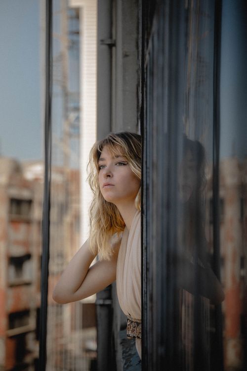Contemplative Woman on Urban Balcony in Istanbul · Free Stock Photo