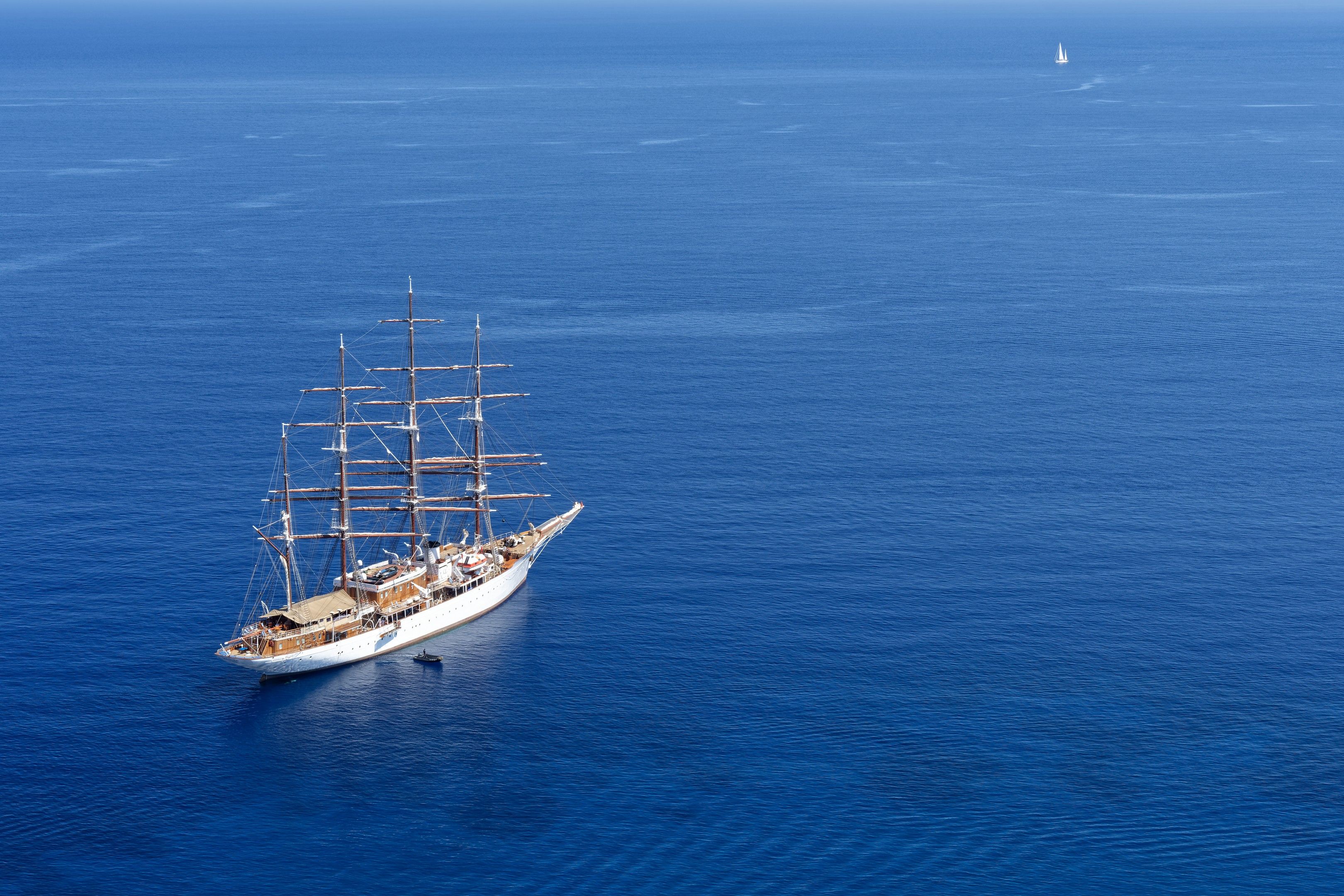 Aerial view of a classic sailing ship in the deep blue Aegean Sea near Greece.
