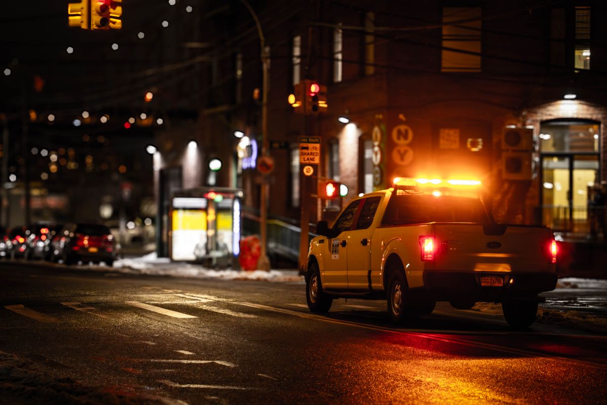 Two Bullies Towing truck on Austin city streets at night