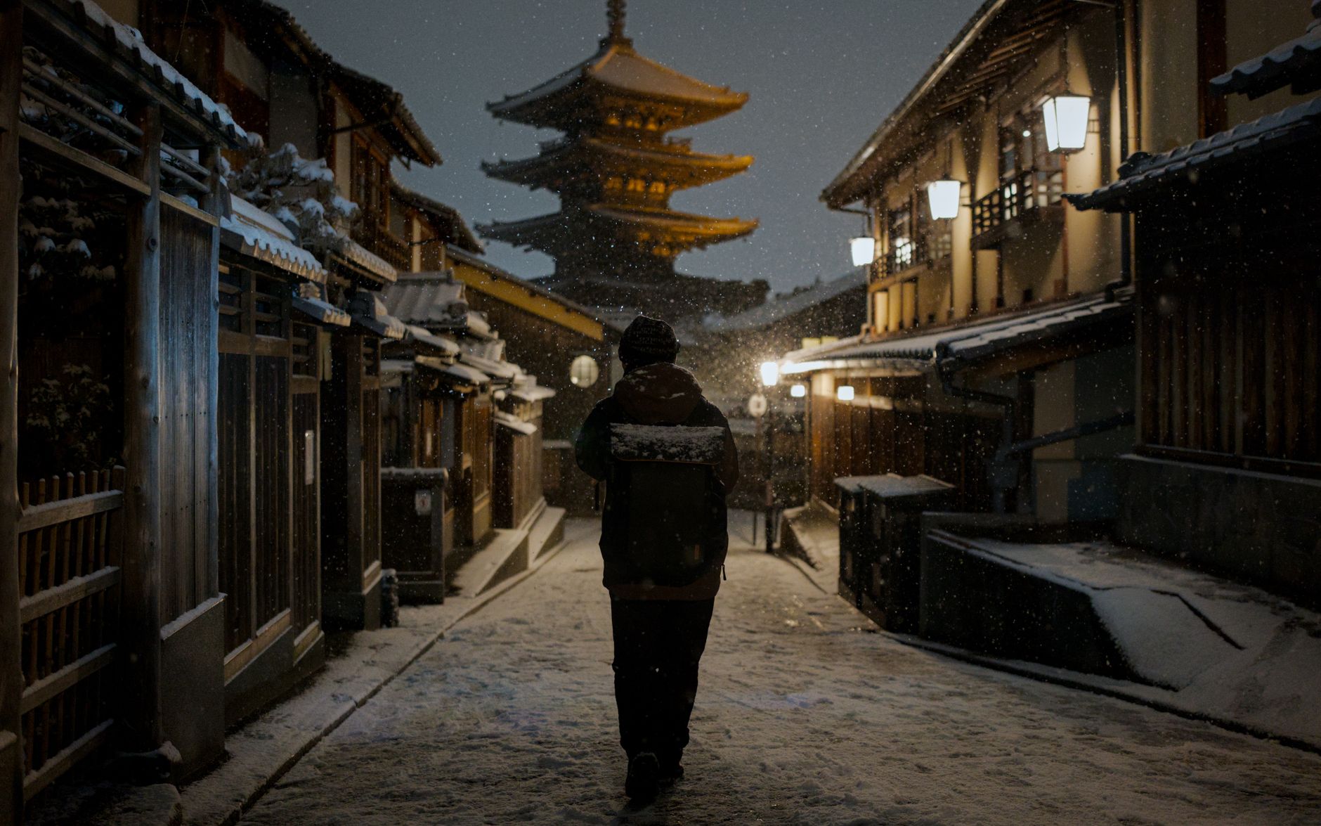 A snowy Higashiyama lane at night with Yasaka Pagoda ahead, Kyoto, Japan