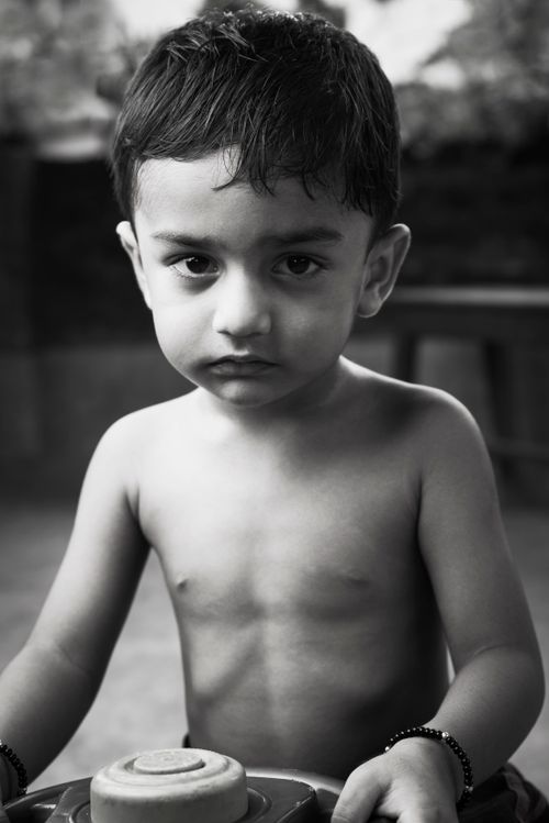 Free Monochrome image of a young child expressing innocence and curiosity. Stock Photo