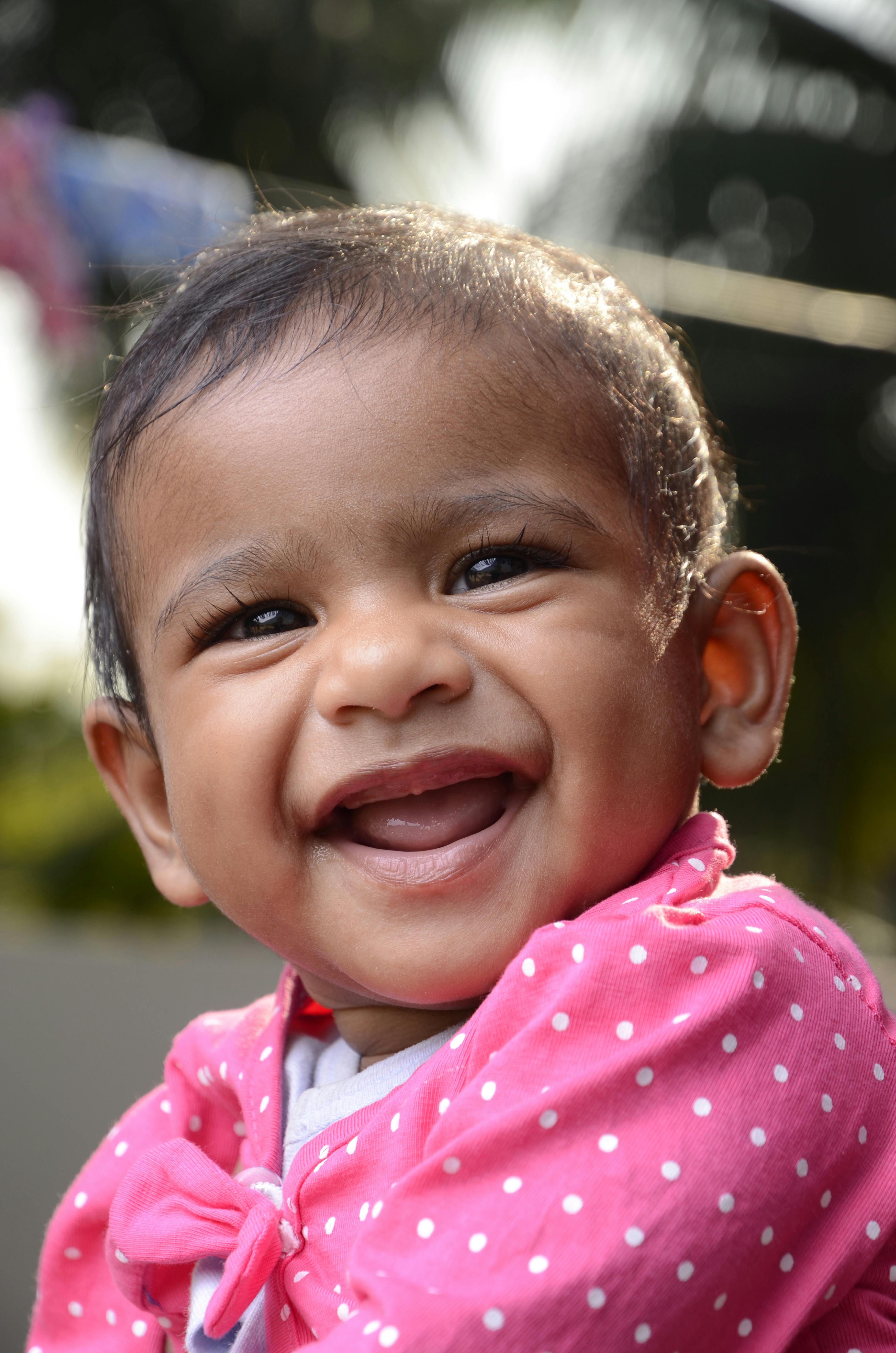 toddler in pink and white polka dot shirt