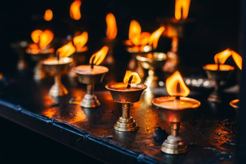 Free Warm glowing oil lamps in brass holders, symbolizing light and spirituality. Stock Photo