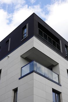 Contemporary architecture of a Warsaw apartment building under a blue sky.