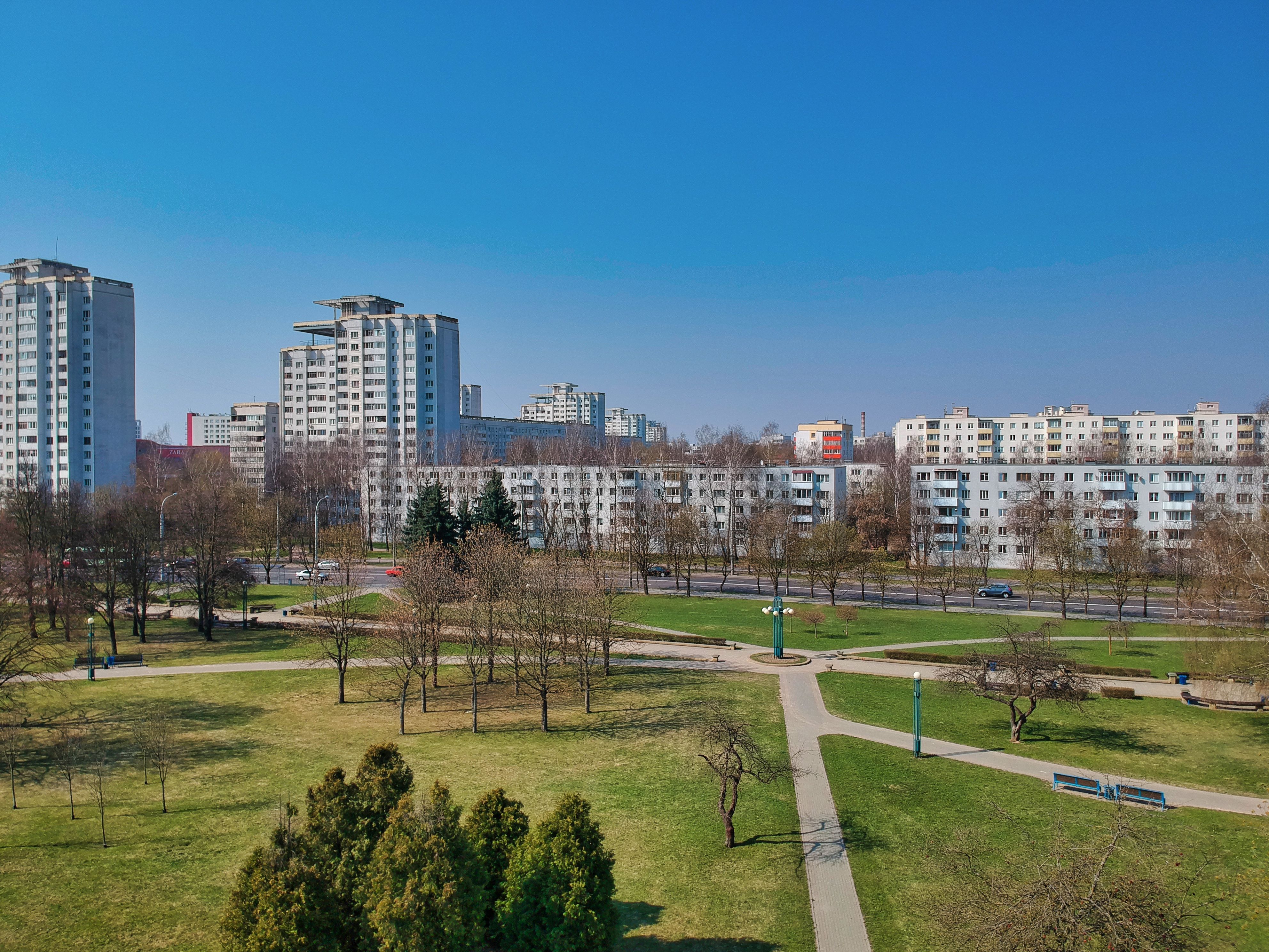 Aerial view of European city in early spring showing parks and urban landscape with emerging greenery