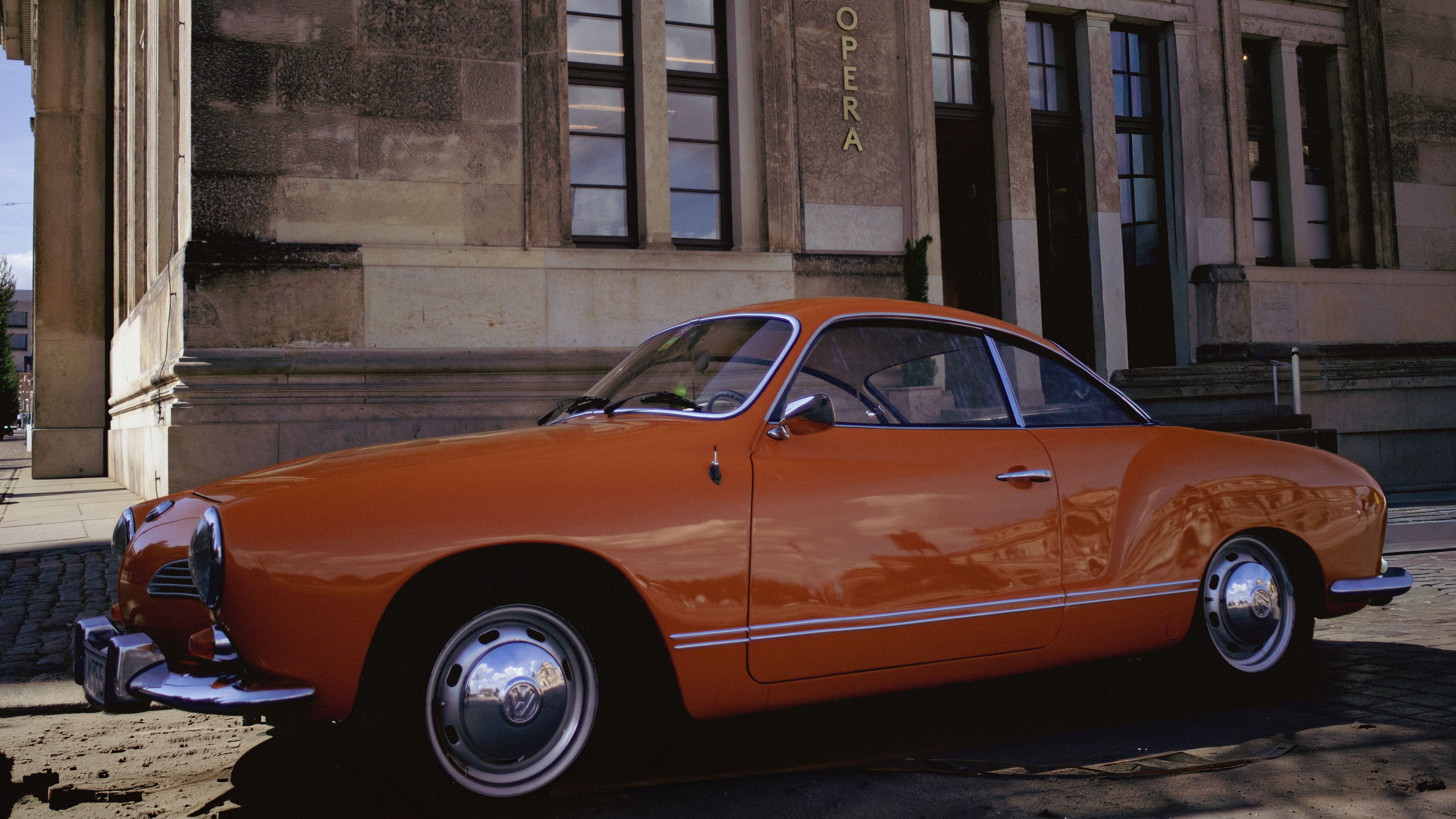 Vintage Orange Car in Front of Opera House · Free Stock Photo