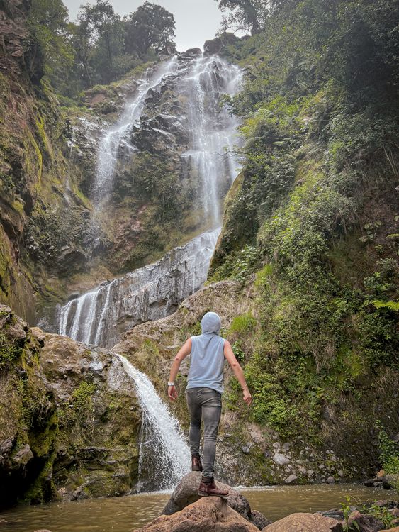 Explor Waterfall Adventurer Exploring a Majestic Waterfall · Free Stock Photo