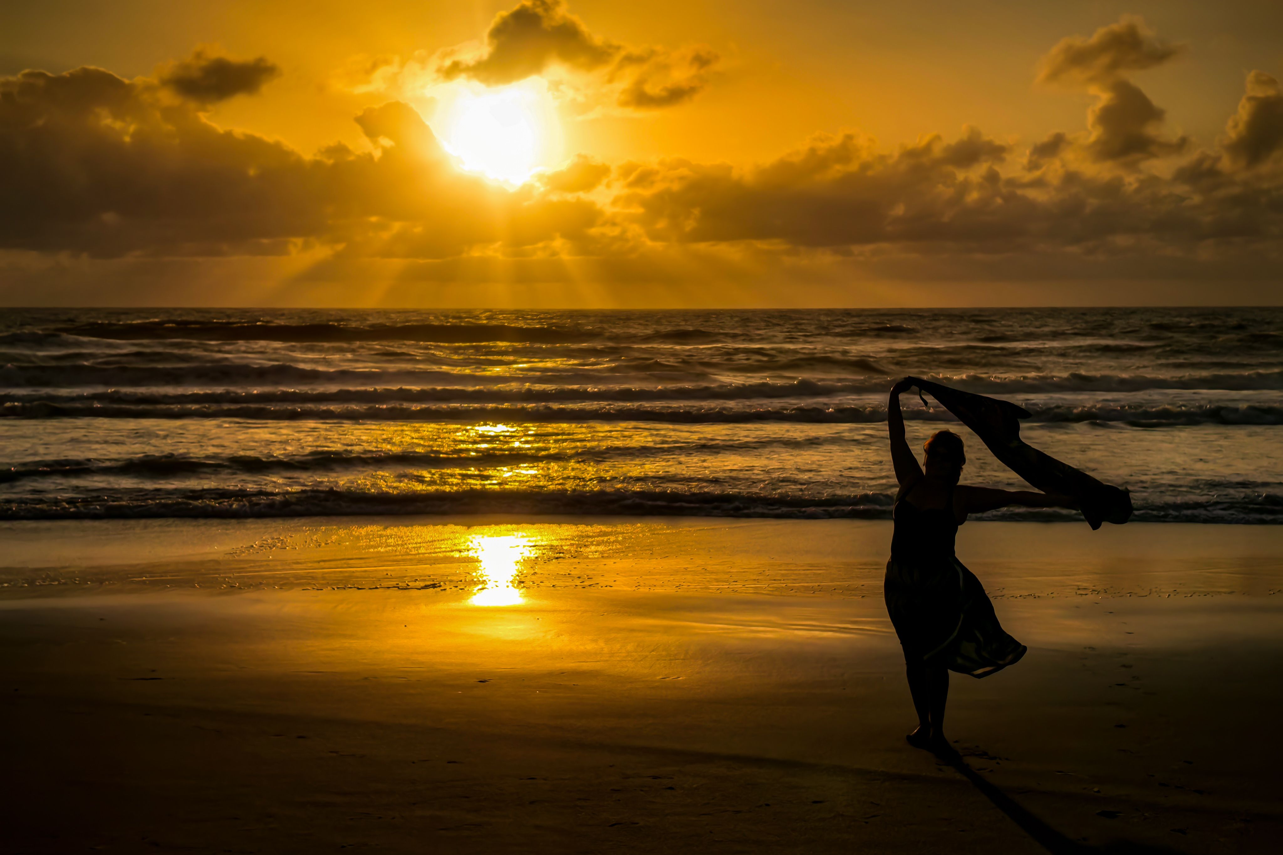 Silhouette of Woman Dancing at Sunset Beach · Free Stock Photo